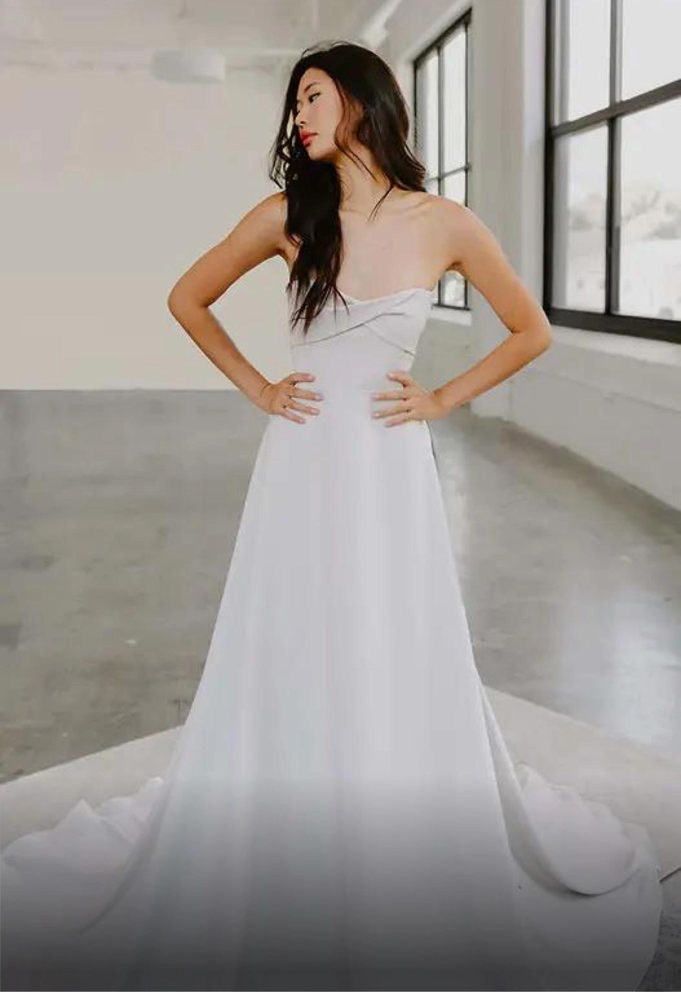 Model wearing a white gown by A-Line