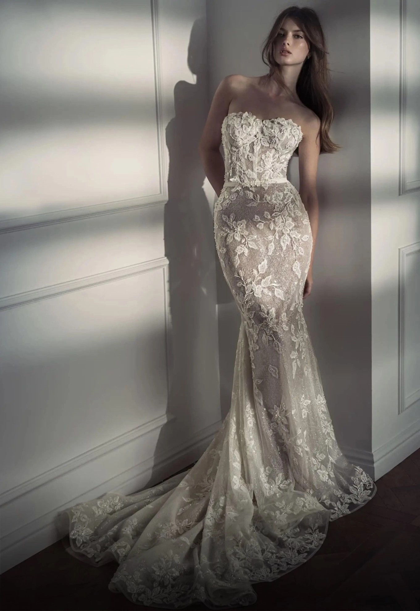 Model wearing a white gown by Fit & Flare