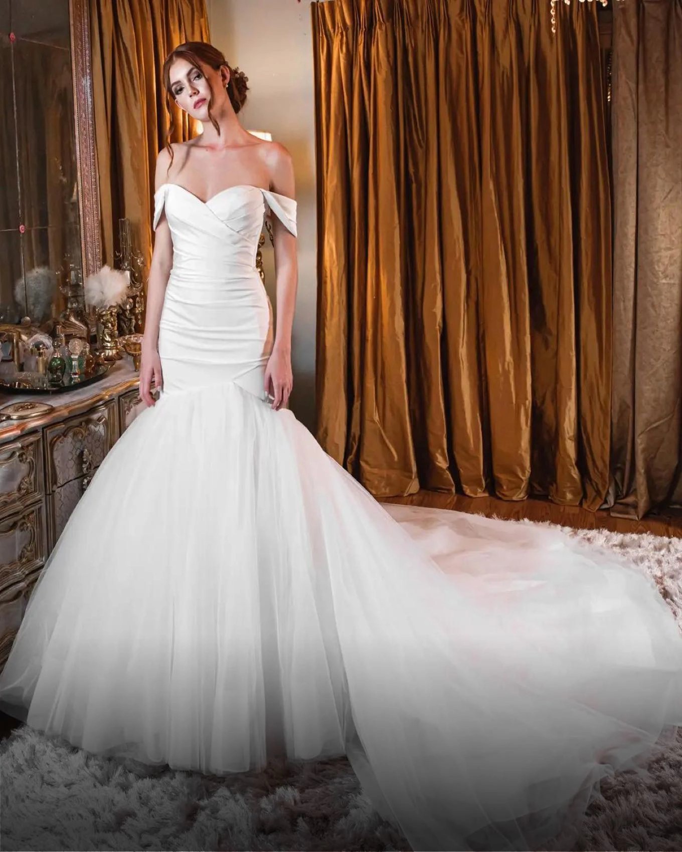 Model wearing a white gown by Mermaid