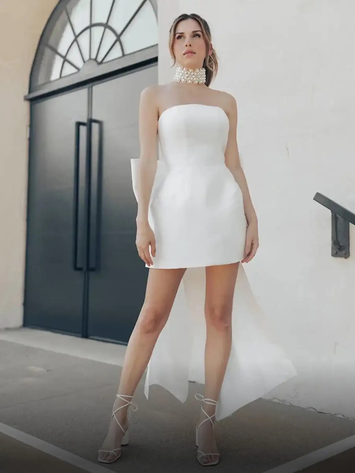 Model wearing a white gown by Shorties & Jumpsuits
