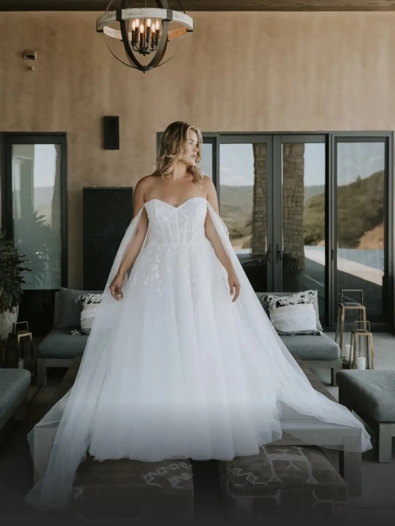 Model wearing a white gown by Plus Size