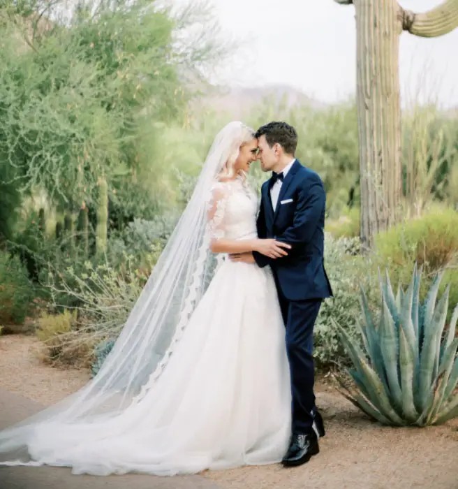 Сouple wearing a white gown and a black suit